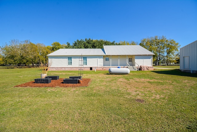 rear view of house with a yard