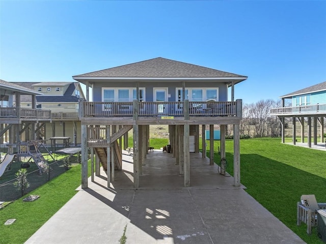 rear view of property featuring a lawn