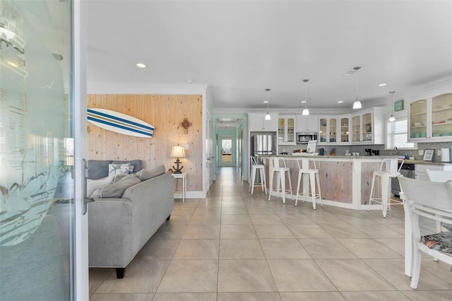 living room featuring crown molding and light tile floors