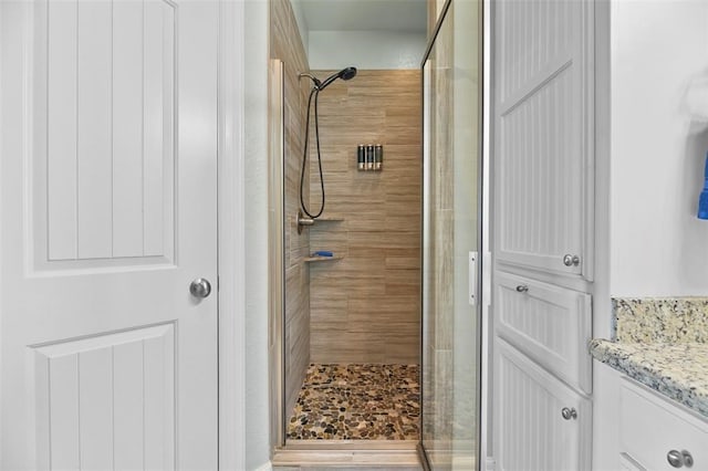 bathroom with walk in shower and vanity