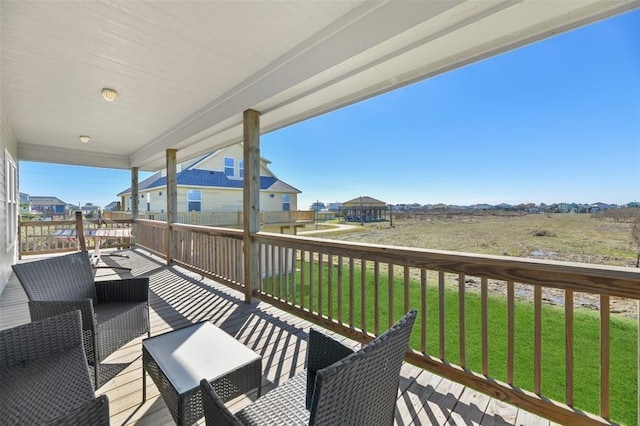 wooden deck featuring an outdoor living space and a yard