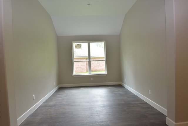 unfurnished room featuring dark hardwood / wood-style floors and lofted ceiling