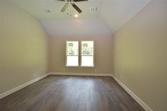 empty room with ceiling fan, dark hardwood / wood-style flooring, and lofted ceiling