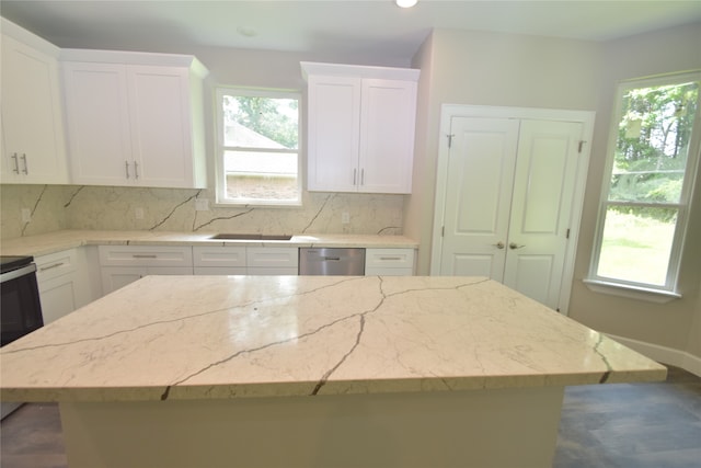 kitchen featuring a center island, a wealth of natural light, and white cabinets