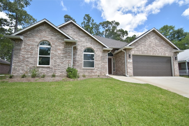 view of front of property featuring a garage and a front yard