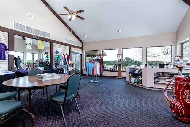 carpeted dining room featuring high vaulted ceiling and ceiling fan