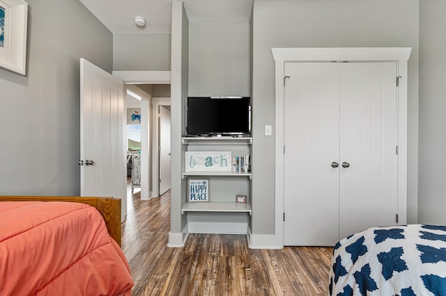 bedroom with a closet and dark hardwood / wood-style floors