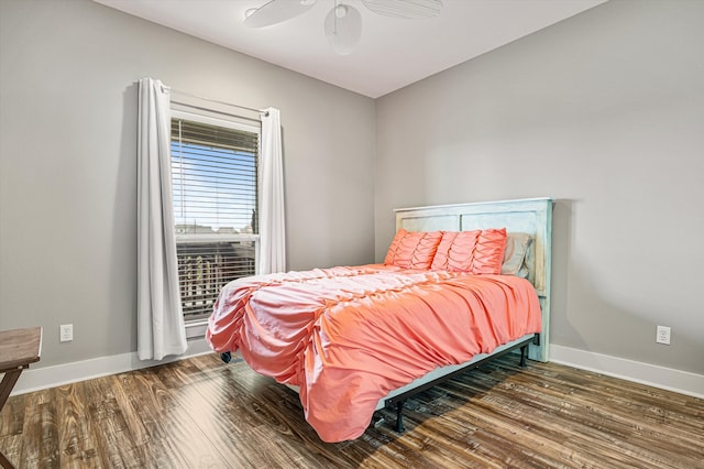 bedroom with dark hardwood / wood-style flooring and ceiling fan