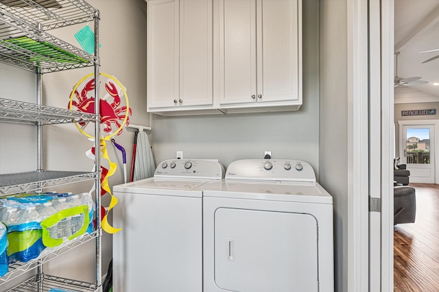 laundry room with washer and dryer, cabinets, hardwood / wood-style flooring, and ceiling fan