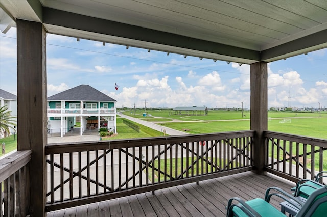 wooden deck with a lawn