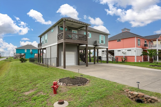 view of front facade with a front yard, a garage, and a balcony