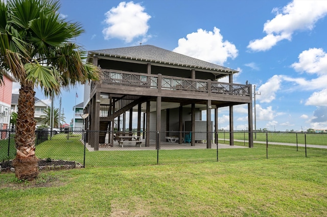 rear view of property with a patio, a wooden deck, and a yard