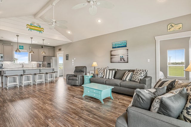 living room featuring ceiling fan, beam ceiling, dark hardwood / wood-style flooring, high vaulted ceiling, and sink