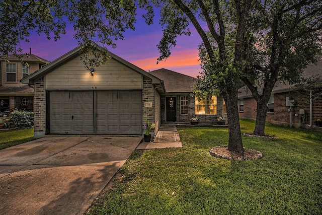 view of front facade with a lawn and a garage