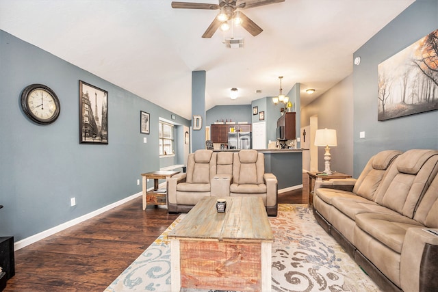 living room with hardwood / wood-style flooring, ceiling fan with notable chandelier, and lofted ceiling