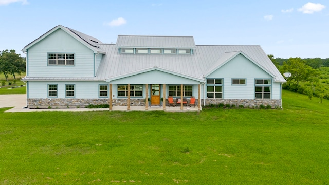 back of property featuring a patio area and a yard