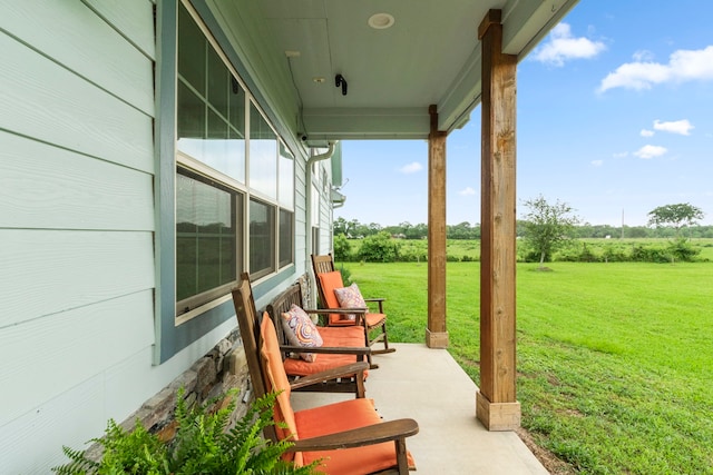 view of patio / terrace with a porch and a rural view