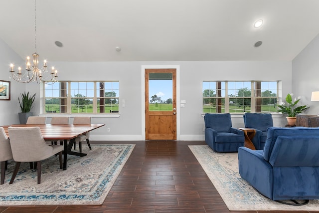 interior space featuring a notable chandelier, dark hardwood / wood-style flooring, lofted ceiling, and a wealth of natural light