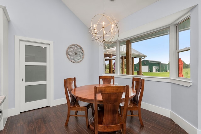 dining space with a notable chandelier, dark hardwood / wood-style flooring, and lofted ceiling