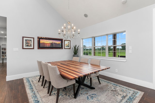 dining area featuring high vaulted ceiling, dark wood-type flooring, and an inviting chandelier