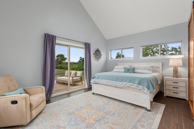 bedroom featuring access to exterior, dark hardwood / wood-style flooring, and high vaulted ceiling