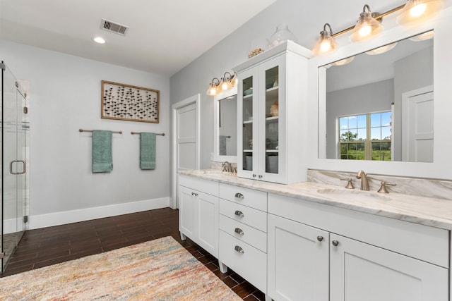 bathroom with vanity and an enclosed shower