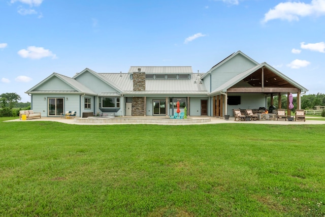 rear view of property with a patio area and a lawn