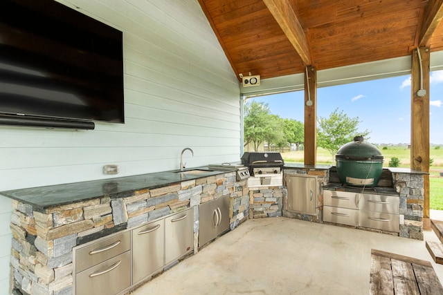 view of patio / terrace featuring an outdoor kitchen, grilling area, and sink