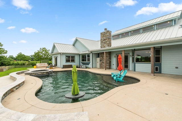 view of swimming pool featuring an in ground hot tub and a patio