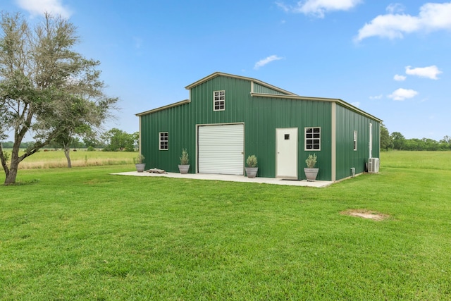 view of outdoor structure featuring a lawn and a garage