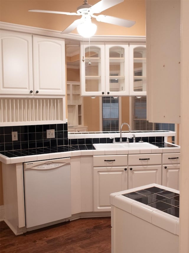 kitchen with tile countertops, dishwasher, and white cabinets