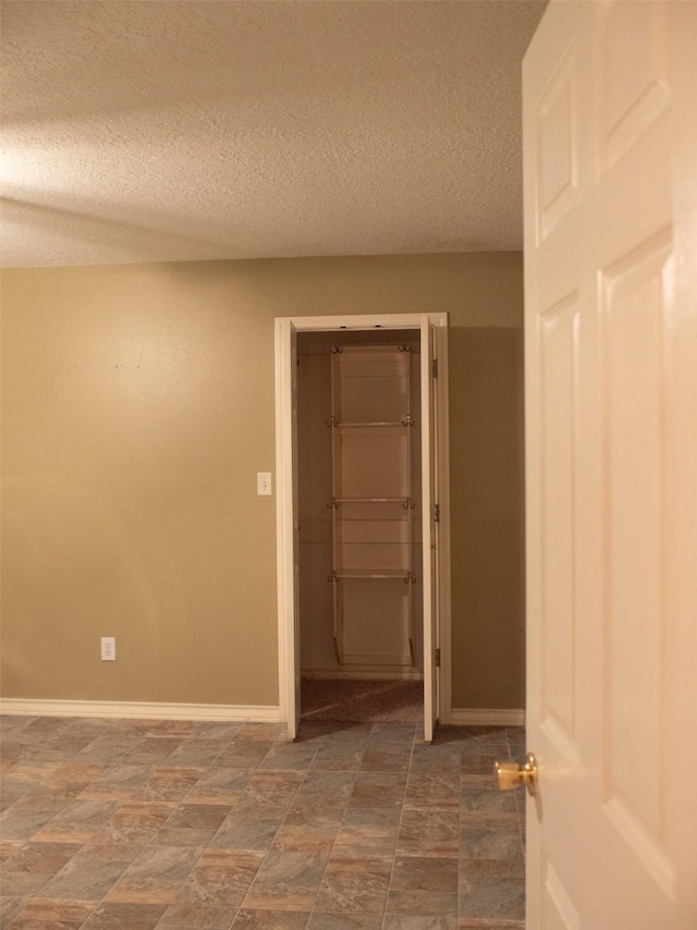 spare room featuring a textured ceiling