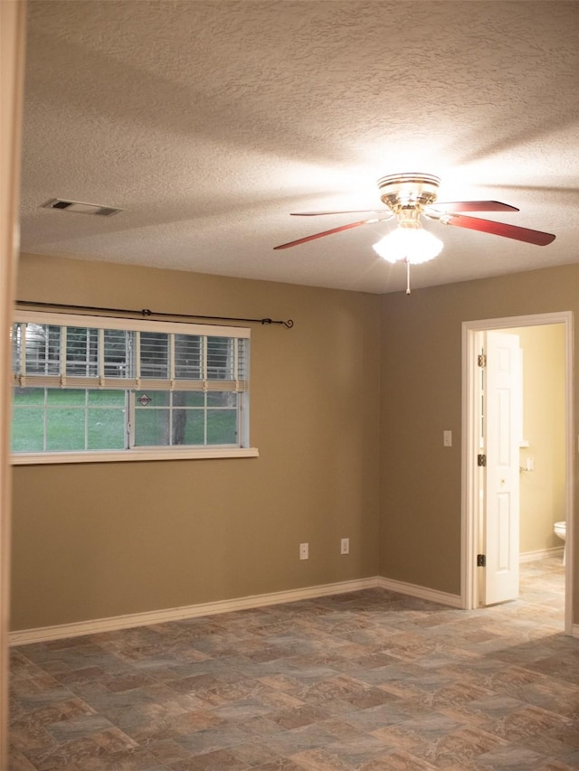 unfurnished room featuring a textured ceiling