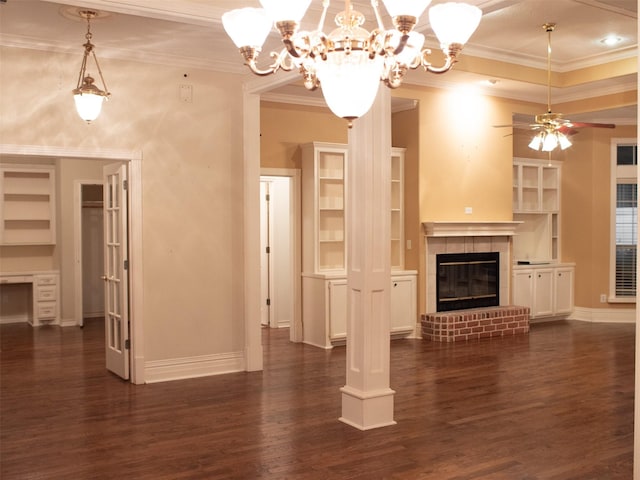 unfurnished living room featuring dark hardwood / wood-style floors, built in features, ornamental molding, and ceiling fan with notable chandelier