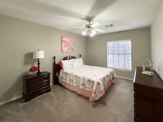 bedroom featuring ceiling fan, carpet floors, and a textured ceiling