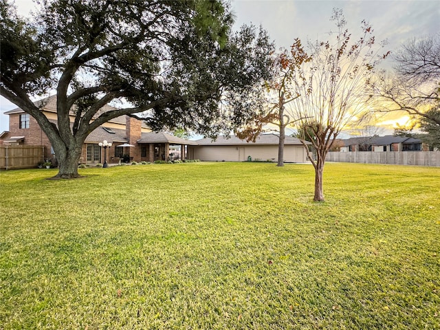 view of yard at dusk