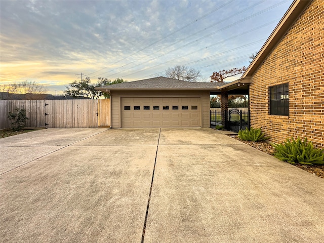 view of garage at dusk