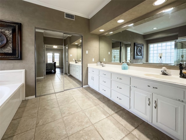 bathroom with crown molding, tile flooring, a bath to relax in, and double sink vanity