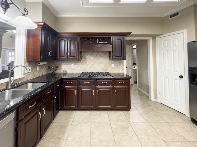 kitchen featuring crown molding, sink, dark stone countertops, and gas cooktop