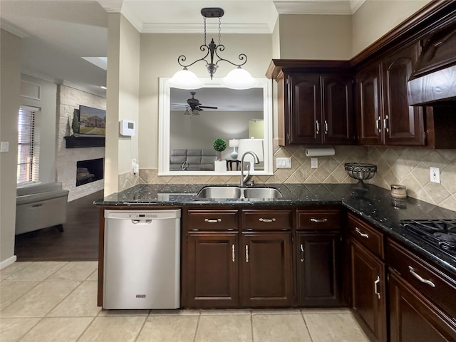 kitchen featuring ceiling fan, a large fireplace, sink, dishwasher, and light tile floors