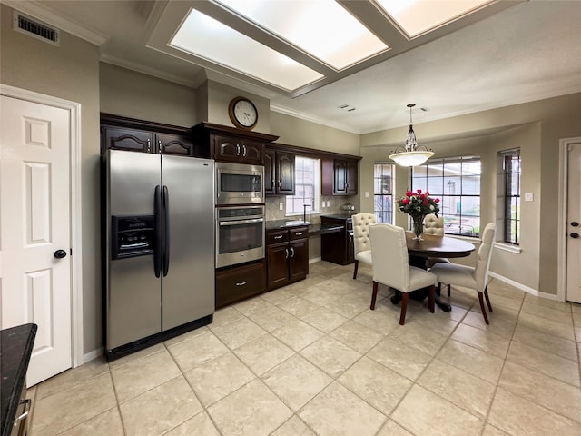 kitchen with stainless steel appliances, backsplash, dark brown cabinets, light tile floors, and pendant lighting