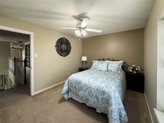 carpeted bedroom with a textured ceiling and ceiling fan