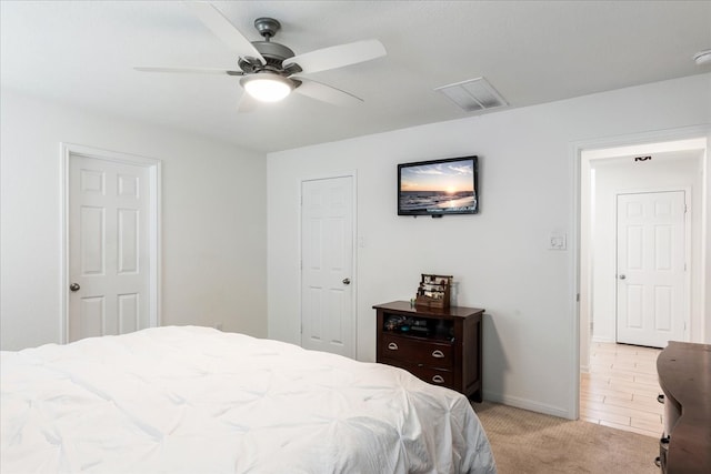 bedroom with light carpet and ceiling fan