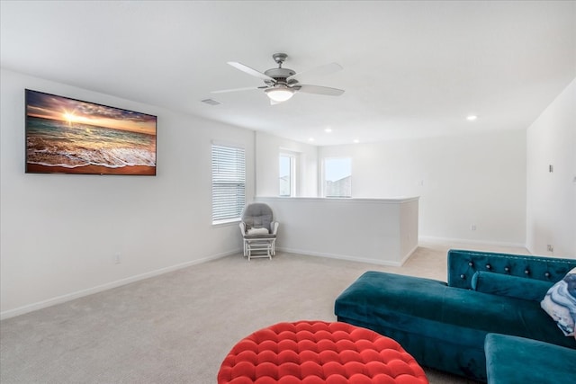 sitting room featuring ceiling fan and light colored carpet