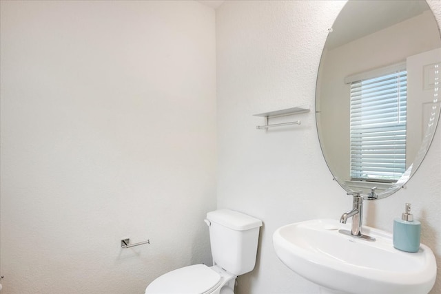 bathroom with toilet and sink