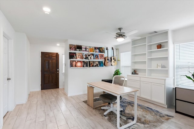 office area featuring ceiling fan, plenty of natural light, and light wood-type flooring