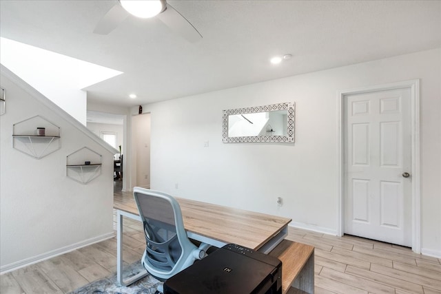 office with ceiling fan and light hardwood / wood-style floors