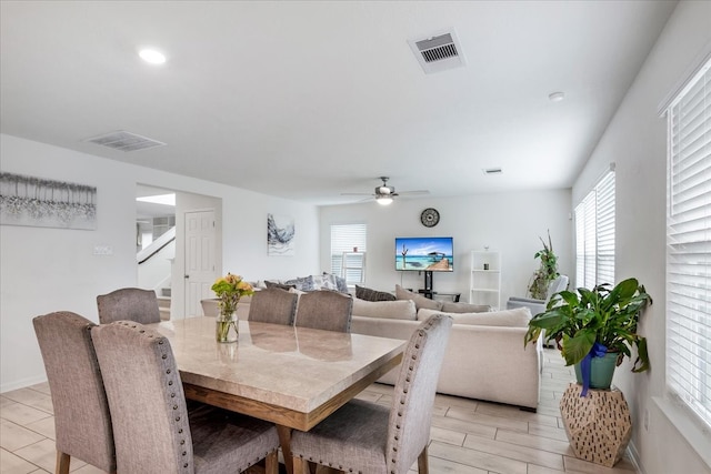 dining space with light hardwood / wood-style floors and ceiling fan