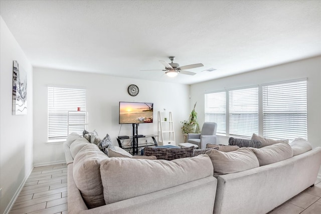 living room featuring ceiling fan and light hardwood / wood-style flooring