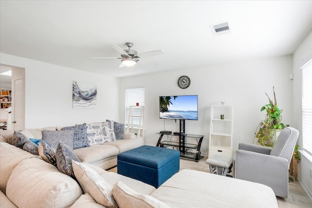 living room with ceiling fan and light hardwood / wood-style floors